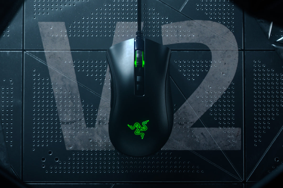 Razer DeathAdder V2 in Black from above on a dark metal mesh background with a large V2 mark