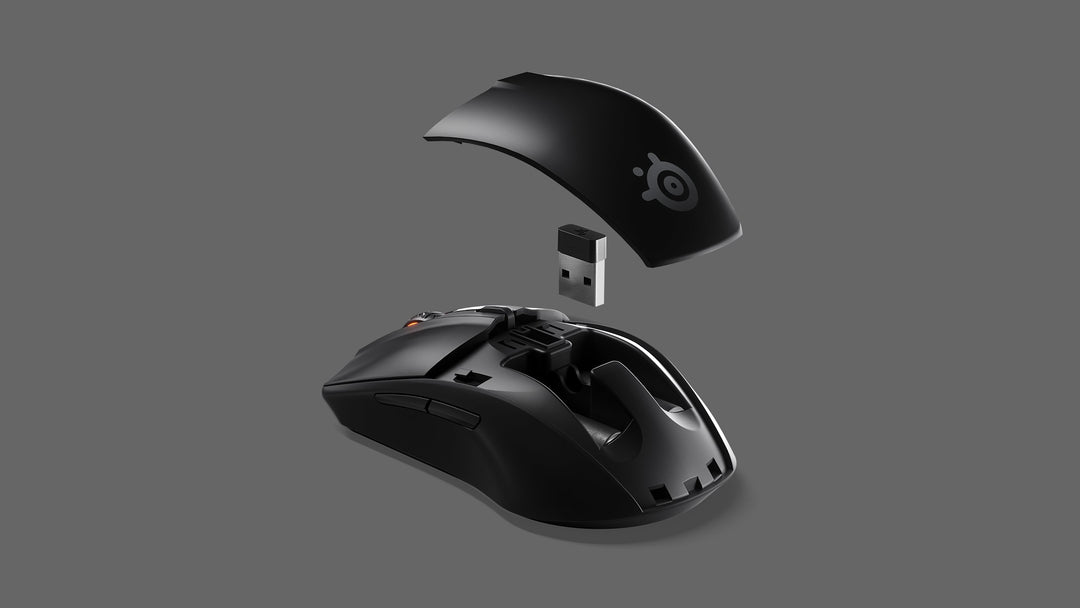 SteelSeries Rival 3 Wireless in Black with the top cover lifted off, showing where the USB wireless dongle stores inside the mouse