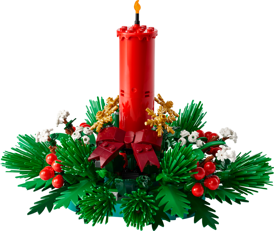 Built LEGO Christmas Table Decoration: a red candle with red berries, golden stars and green foliage on white background