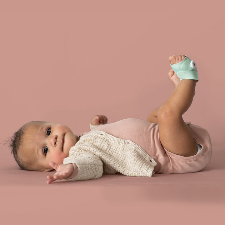 Infant wearing the Owlet Smart Sock 3 mint sock, official photography