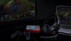 AVerMedia Live Gamer Portable 2 Plus beside a gaming headset and controller in a console streaming setup