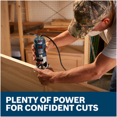 Woodworker routing the edge of a large panel with the Bosch Colt PR20EVS