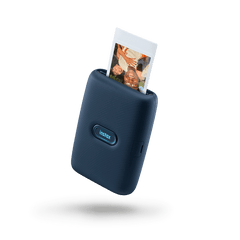 Fujifilm INSTAX Mini Link smartphone printer in Dark Denim, printing an INSTAX Mini photo