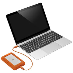LaCie Rugged USB-C portable hard drive connected to a laptop by its orange USB-C cable