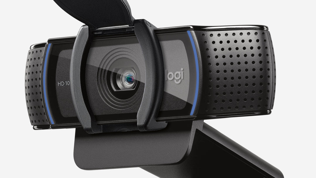Close-up of the Logitech C920s five-element HD glass lens behind the open privacy shutter