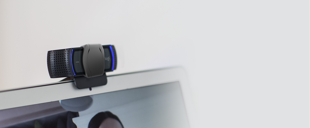 Logitech C920s Pro HD Webcam with privacy shutter closed, clipped to the top edge of a laptop screen