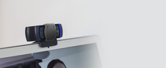 Logitech C920s Pro HD Webcam with privacy shutter closed, clipped to the top edge of a laptop screen