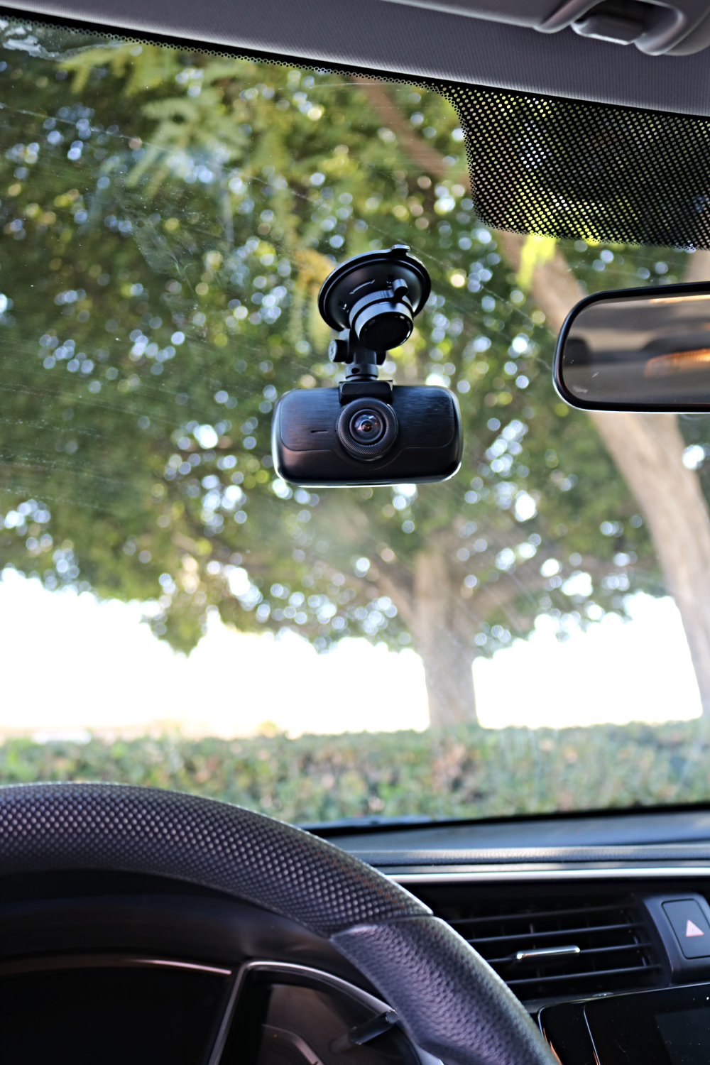 myGEKOgear Orbit 960 dash cam on its suction cup mount behind a car windshield