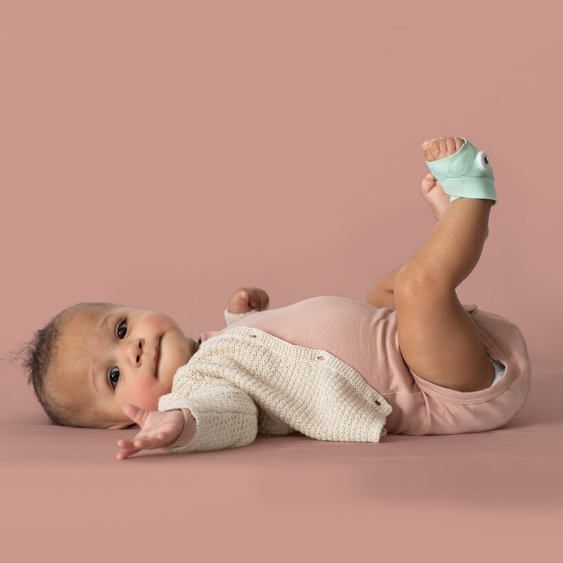 Owlet Smart Sock 3 in Mint worn on a baby's foot, official photography