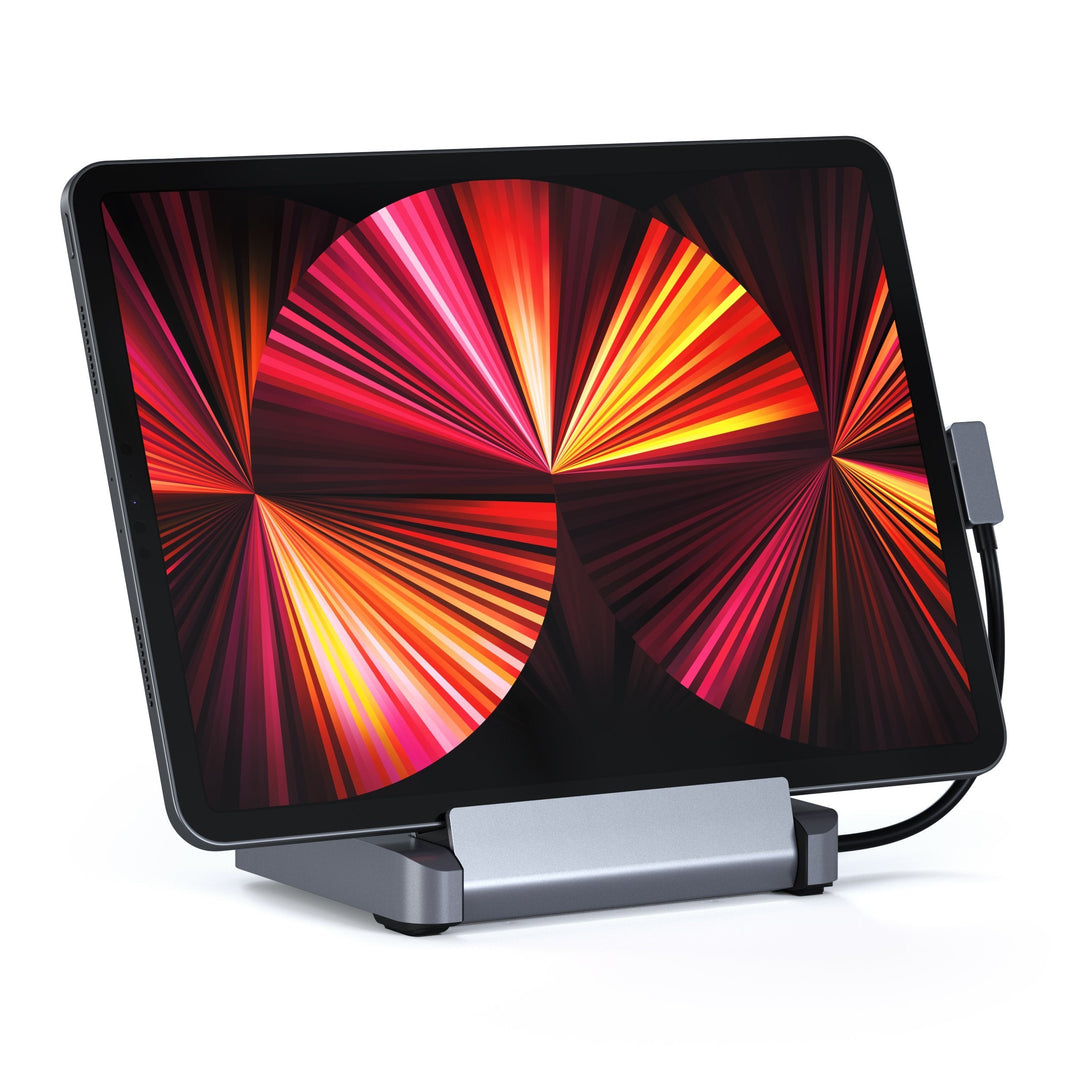 Satechi Aluminum Stand & Hub for iPad Pro in space gray holding an iPad Pro upright, front view with the USB-C cable connected