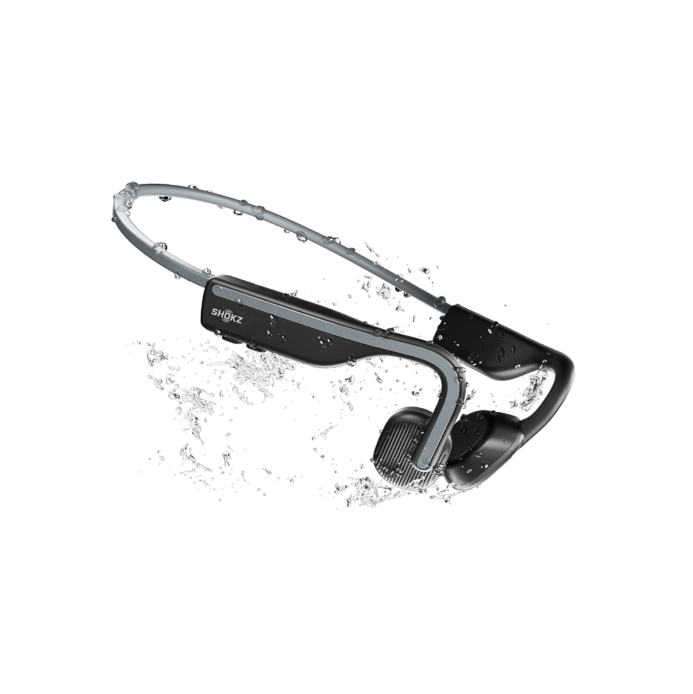 Shokz OpenMove in Slate Grey splashed with water, showing the IP55 sweat and water resistance
