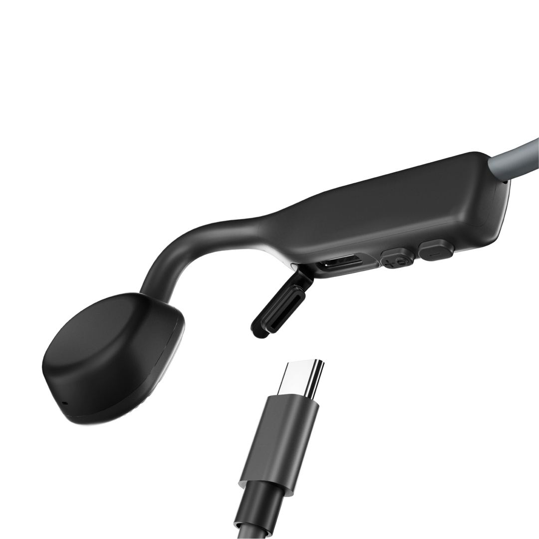Shokz OpenMove Slate Grey control module with the USB-C charging port, volume buttons and a USB-C cable
