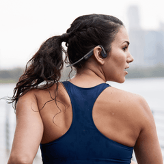 Runner wearing the Shokz OpenMove in Slate Grey, open ear with the band behind the head