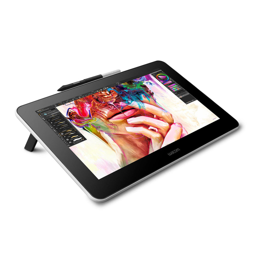 Wacom One 13.3 inch pen display at an angle on its fold-out legs, with the Wacom One Pen in its holder on the top edge