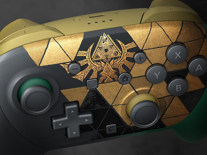 Close-up of the gold Triforce crest and the gold and black triangles on the Zelda 40th Anniversary Pro Controller